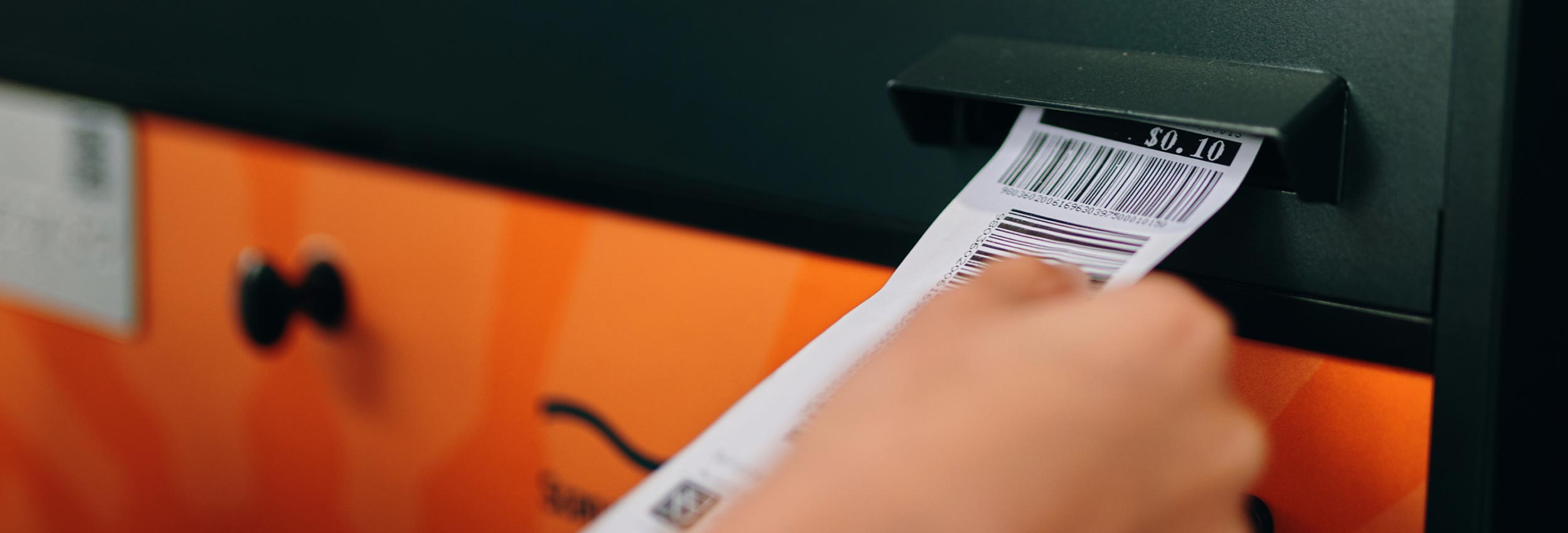 person inserting ticket into machine